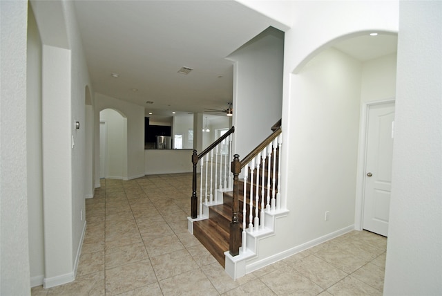 foyer with ceiling fan and light tile patterned flooring