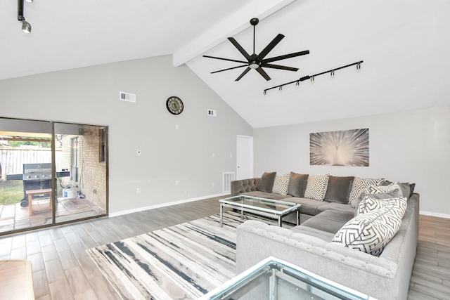 living room with track lighting, ceiling fan, wood-type flooring, high vaulted ceiling, and beamed ceiling