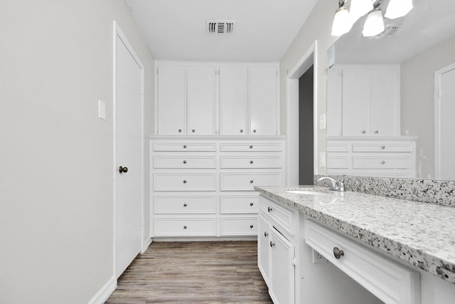 walk in closet featuring hardwood / wood-style flooring and sink