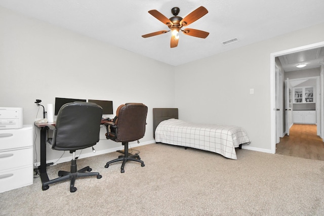 bedroom featuring a ceiling fan, carpet flooring, visible vents, and baseboards