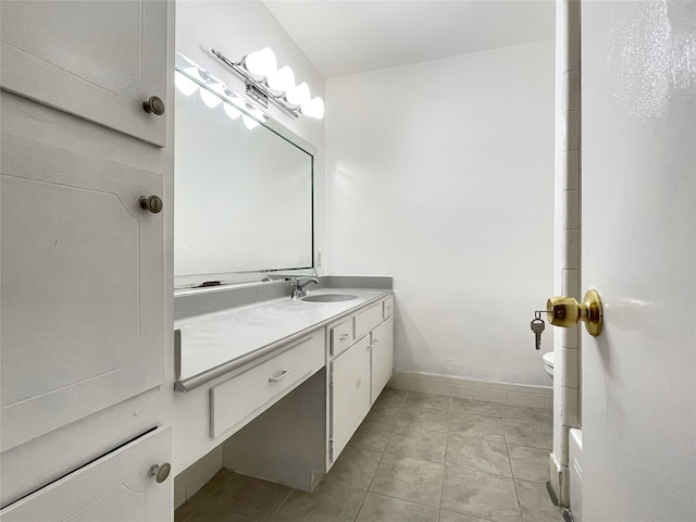 bathroom featuring tile patterned flooring, vanity, and toilet