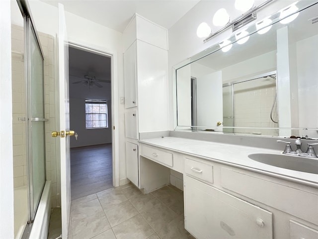 bathroom featuring ceiling fan, tile patterned flooring, bath / shower combo with glass door, and vanity