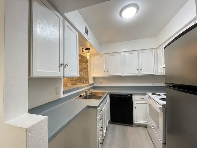 kitchen with electric stove, stainless steel fridge, white cabinetry, black dishwasher, and sink