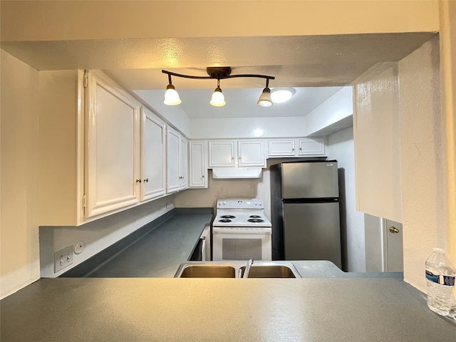 kitchen with electric range, stainless steel refrigerator, pendant lighting, sink, and white cabinetry