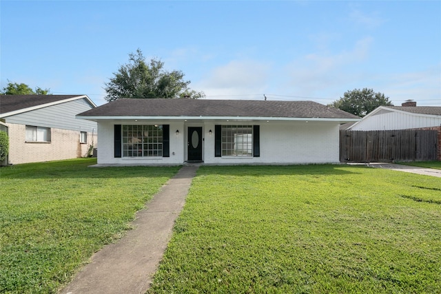 single story home featuring covered porch and a front lawn