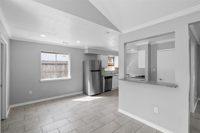 kitchen with lofted ceiling, decorative backsplash, light tile patterned floors, white cabinetry, and stainless steel appliances