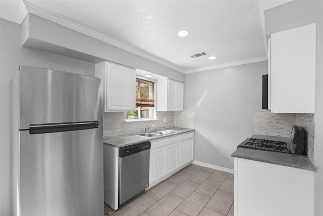 kitchen featuring white cabinetry, sink, light tile patterned flooring, and appliances with stainless steel finishes