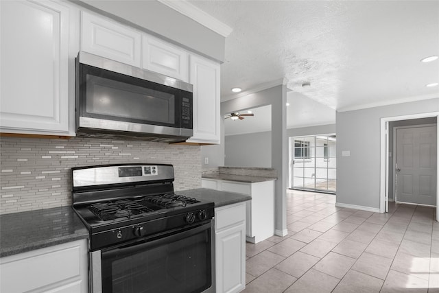 kitchen with appliances with stainless steel finishes, backsplash, ornamental molding, white cabinetry, and light tile patterned flooring