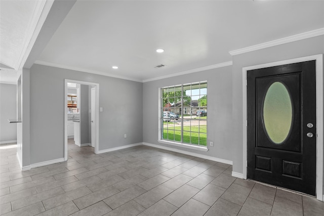 foyer entrance with crown molding and light tile patterned flooring