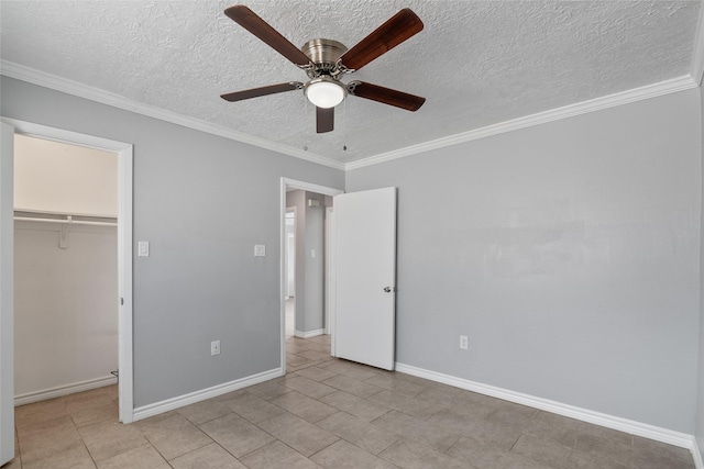 unfurnished bedroom featuring ceiling fan, a spacious closet, ornamental molding, light tile patterned floors, and a closet