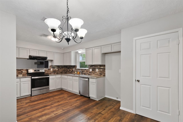 kitchen featuring white cabinets, sink, hanging light fixtures, stainless steel appliances, and a chandelier