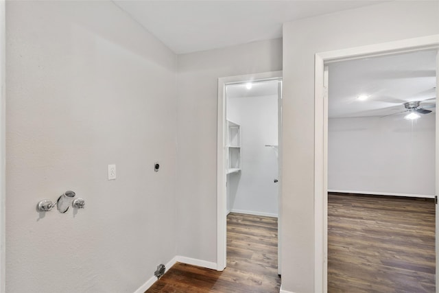 interior space with hookup for an electric dryer, ceiling fan, and dark wood-type flooring