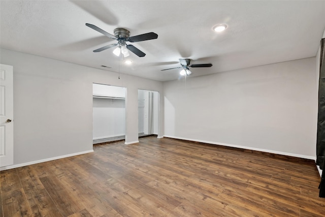 unfurnished bedroom with ceiling fan and dark hardwood / wood-style floors