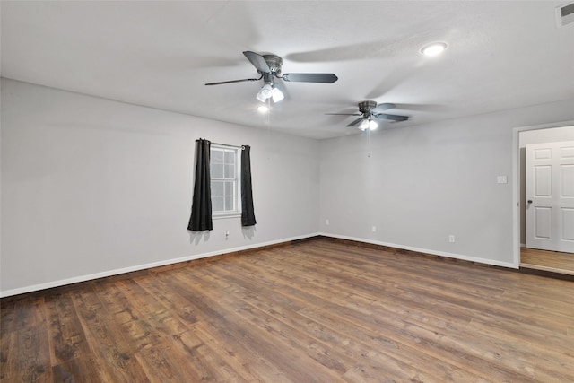 spare room with ceiling fan and dark hardwood / wood-style flooring