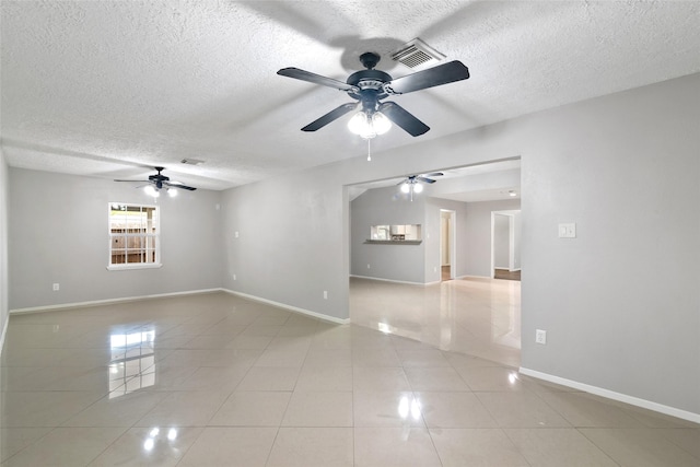 tiled spare room featuring ceiling fan and a textured ceiling