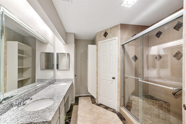 bathroom featuring tile patterned flooring, vanity, and an enclosed shower