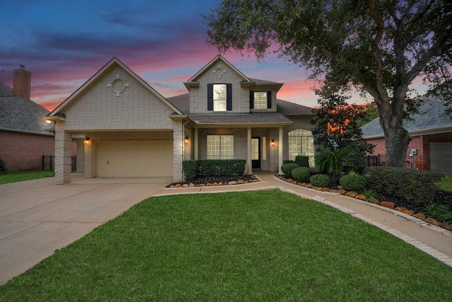 view of front facade featuring a yard and a garage