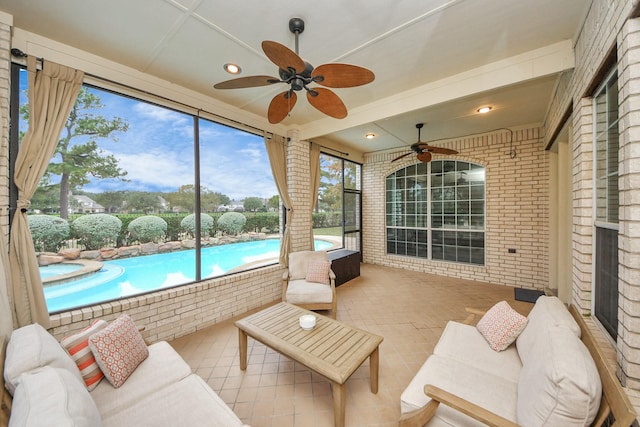 sunroom featuring ceiling fan