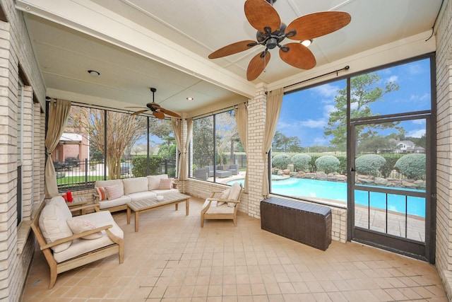 sunroom featuring ceiling fan