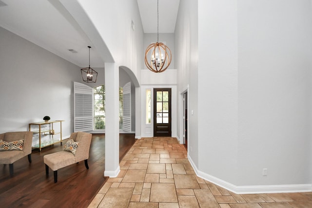 entrance foyer featuring a towering ceiling and a notable chandelier