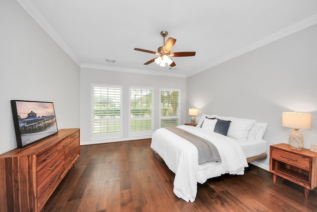 bedroom featuring dark wood-type flooring, ceiling fan, and ornamental molding