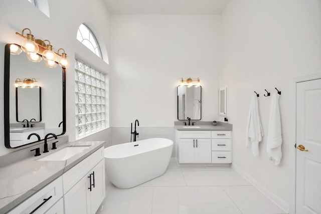 bathroom with tile patterned floors, vanity, and a bathing tub