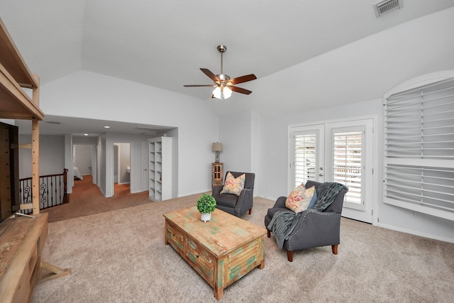 carpeted living room with ceiling fan and lofted ceiling