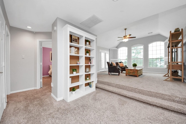 sitting room featuring carpet, vaulted ceiling, and ceiling fan