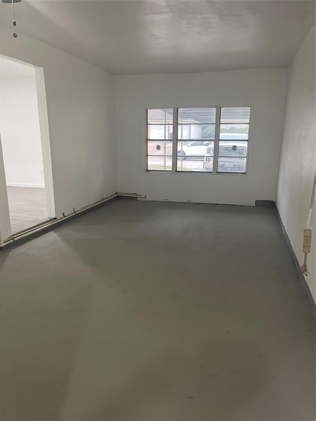 unfurnished room featuring concrete floors and a wealth of natural light