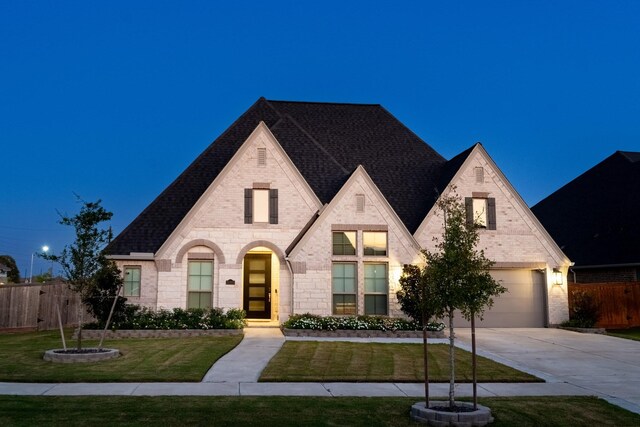 view of front of property featuring a garage and a front yard