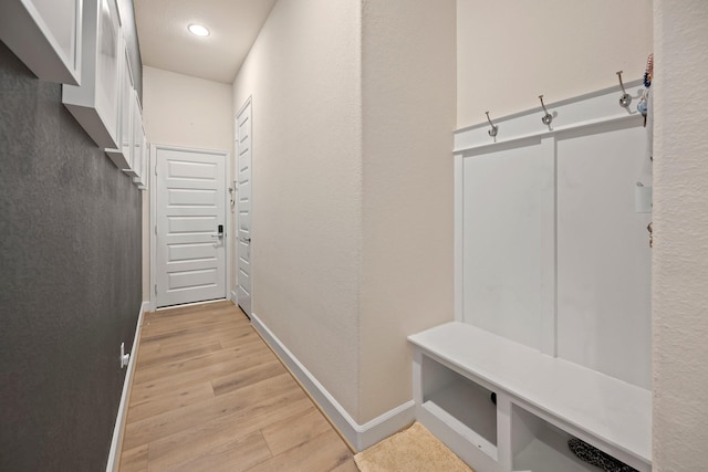 mudroom with light wood-type flooring and baseboards