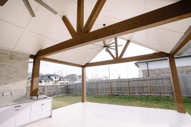 view of patio featuring a sink, a gazebo, and a fenced backyard