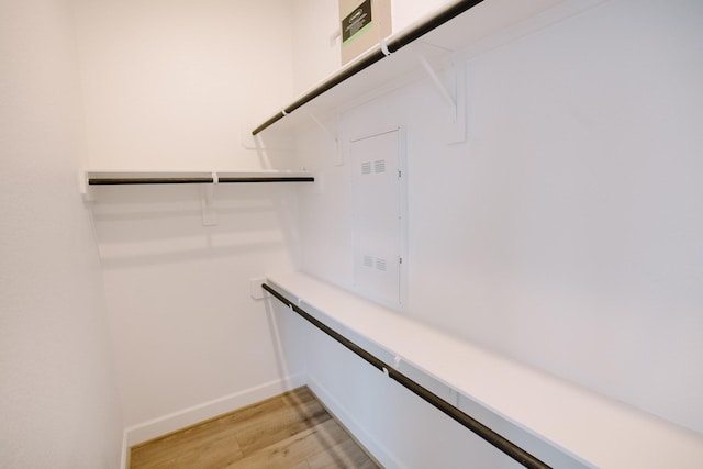 walk in closet with light wood-type flooring