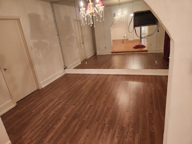 basement featuring dark hardwood / wood-style floors and a chandelier