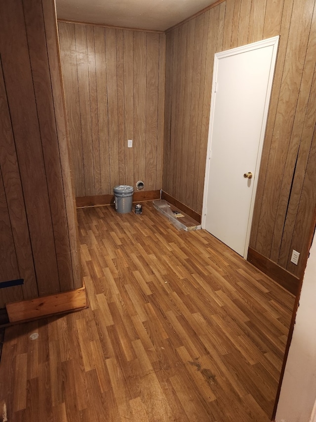 spare room featuring wood walls and hardwood / wood-style floors