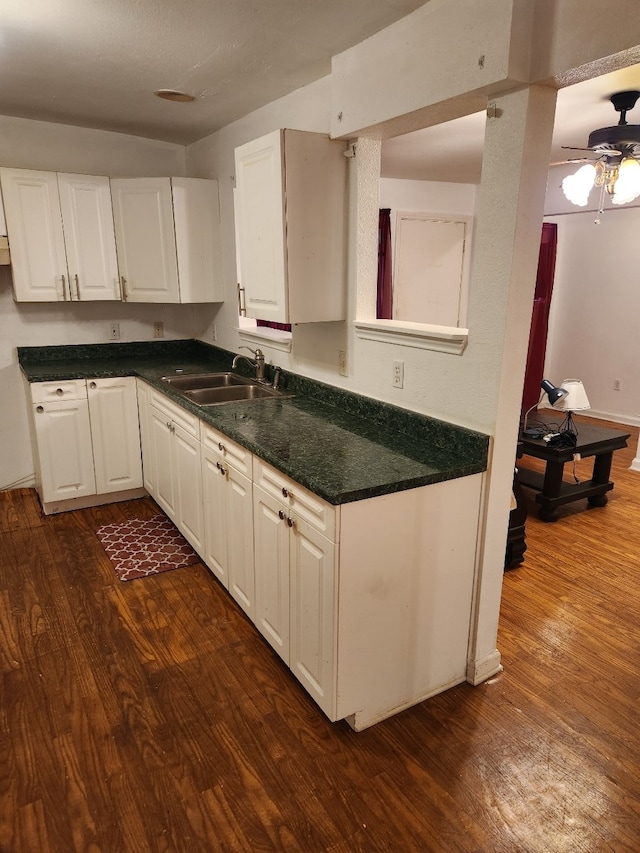 kitchen featuring ceiling fan, sink, white cabinetry, and dark hardwood / wood-style floors