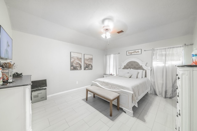 bedroom featuring multiple windows and ceiling fan