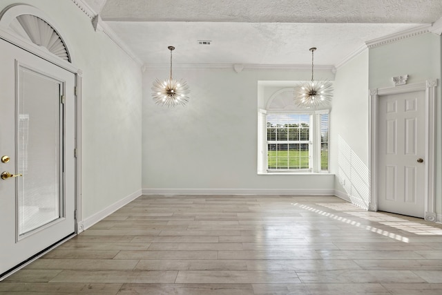 interior space with light hardwood / wood-style floors, crown molding, a textured ceiling, and an inviting chandelier