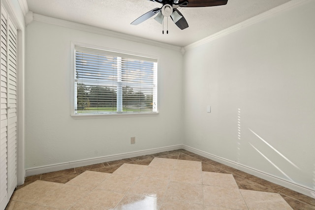 unfurnished room featuring ceiling fan, light tile patterned flooring, and ornamental molding