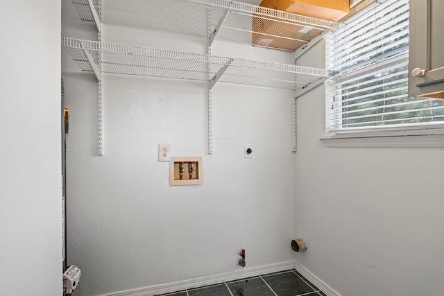 laundry area featuring hookup for an electric dryer, gas dryer hookup, dark tile patterned floors, and hookup for a washing machine