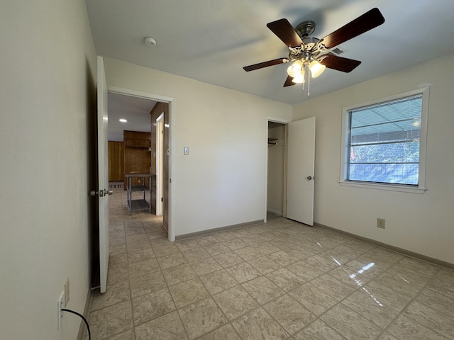 unfurnished bedroom with ceiling fan and a closet