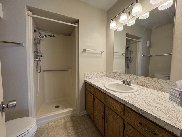 bathroom with toilet, a shower, and vanity