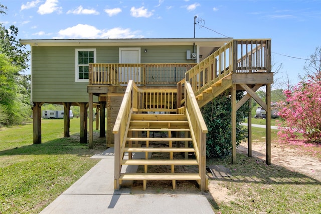 back of house with a lawn and a deck