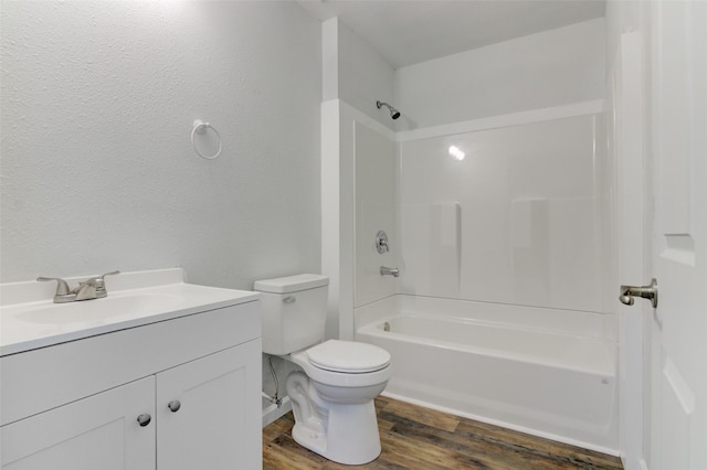 full bathroom featuring hardwood / wood-style floors, vanity, toilet, and shower / tub combination