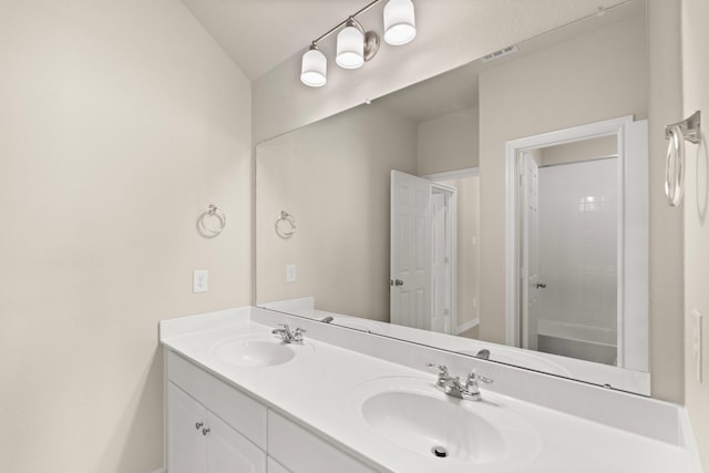 bathroom featuring lofted ceiling, vanity, and bathtub / shower combination