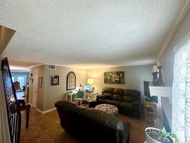 living room with hardwood / wood-style floors, ornamental molding, and a textured ceiling