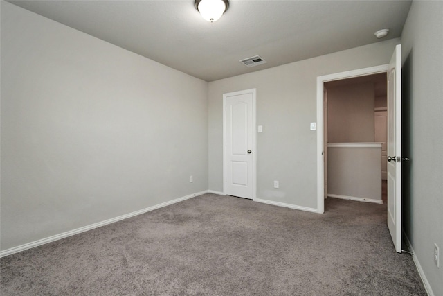 unfurnished bedroom with carpet floors and a closet