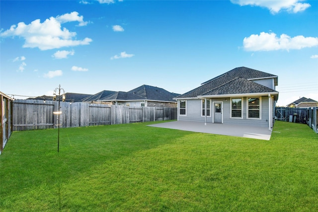 back of house featuring a yard and a patio