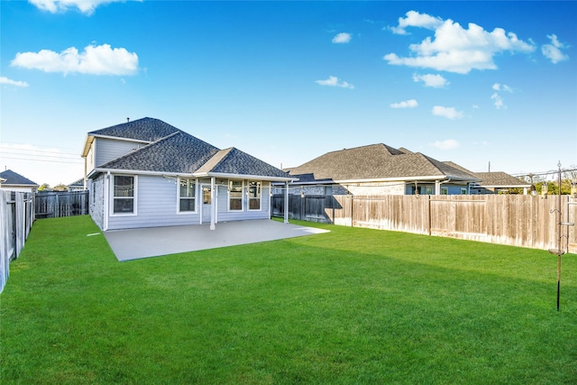 back of house featuring a patio and a lawn