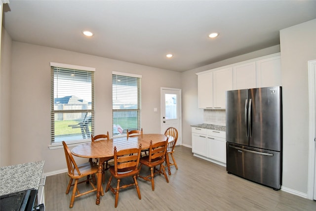 dining space featuring light wood-type flooring